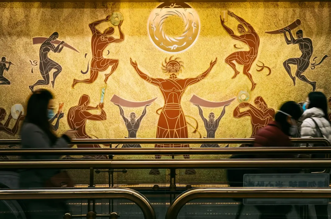 a group of people sitting in front of a painting