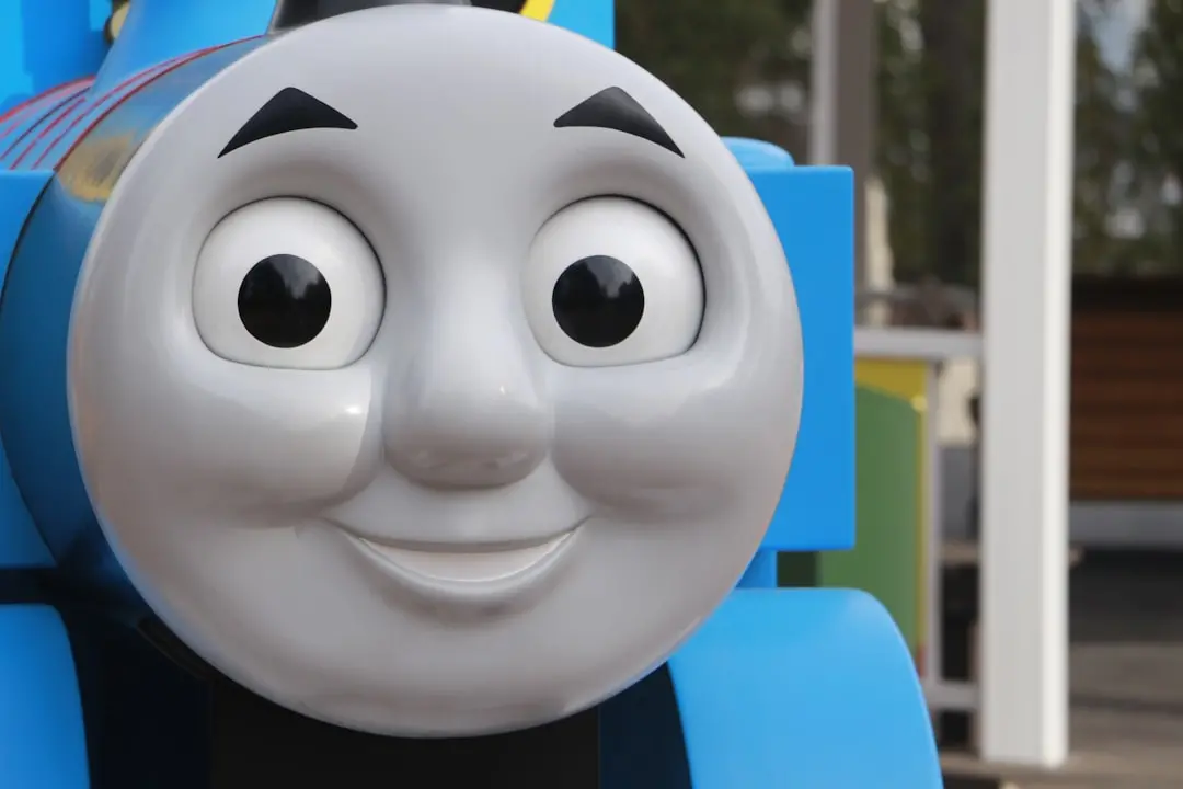 Close-up of a smiling blue cartoon train character.